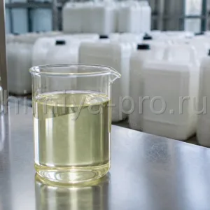 Светло-жёлтое рафинированное масло крамбе в лабораторном стакане на фоне промышленных канистр косметического сырья